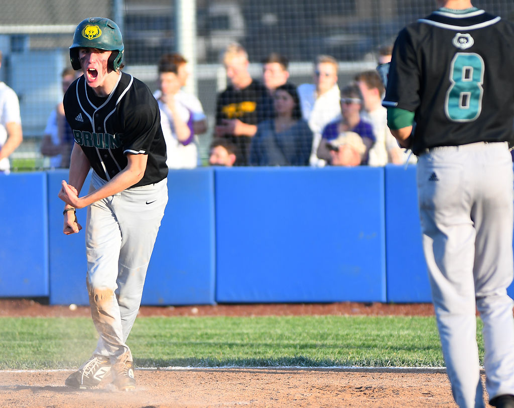 Rock Bridge's Elliot Bachrach screams out in celebration after scoring a run